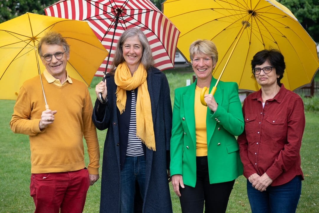 Group photo of the Histon and Impington County and District Councillors with umbrellas